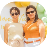 Two friends smiling at a birthday celebration